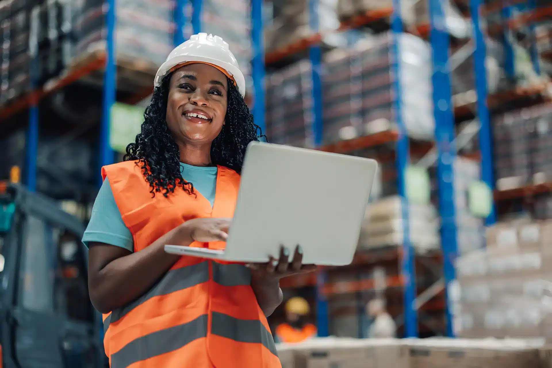 Lady with laptop in factory setting